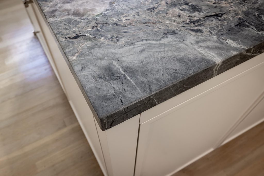 Stone kitchen countertop installation with a custom edge by Stoneman Fabrications in San Francisco